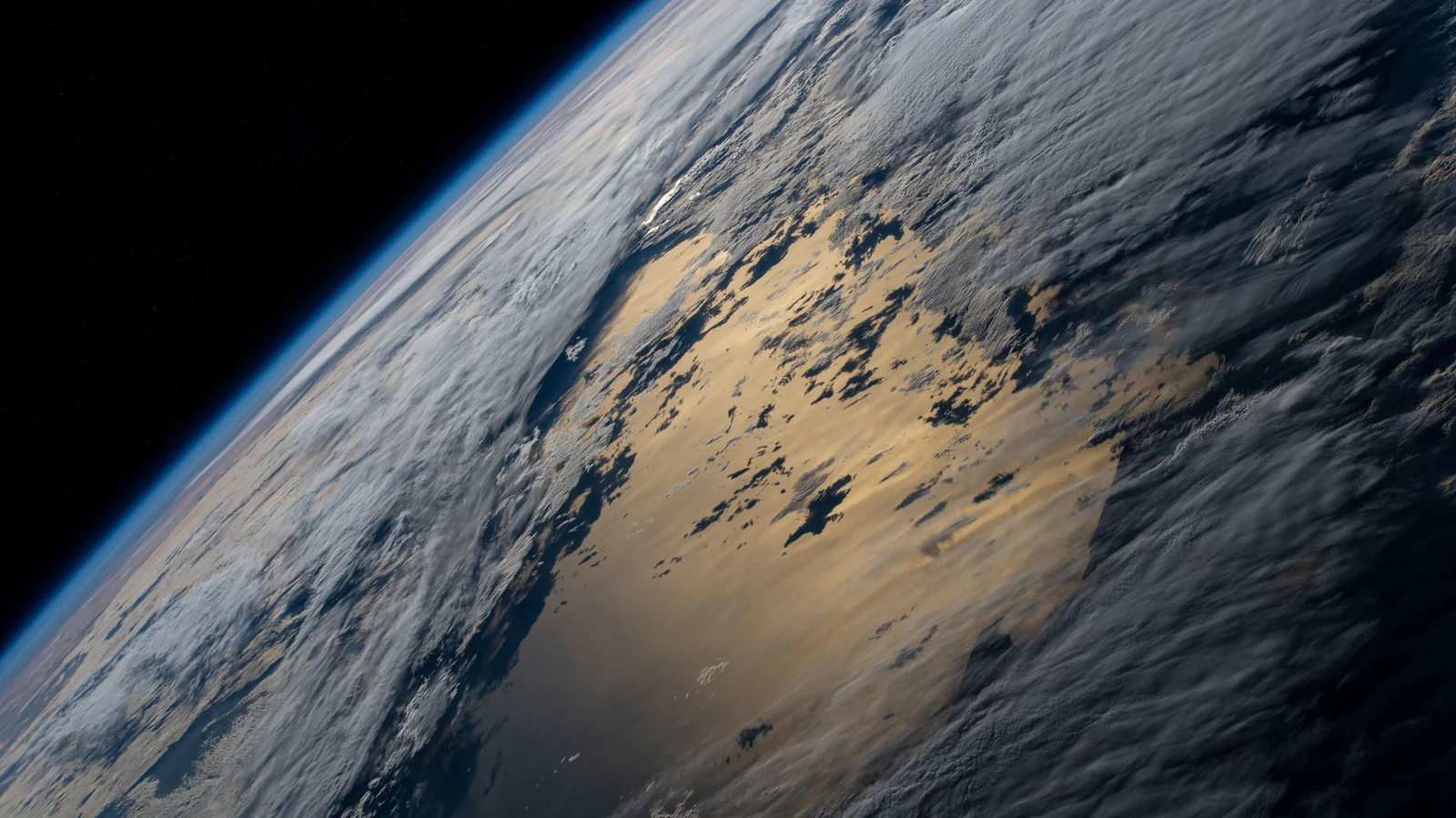 Earth horizon and a cloudy Pacific Ocean